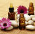 bottles of essence oil with pink flowers - beauty treatment